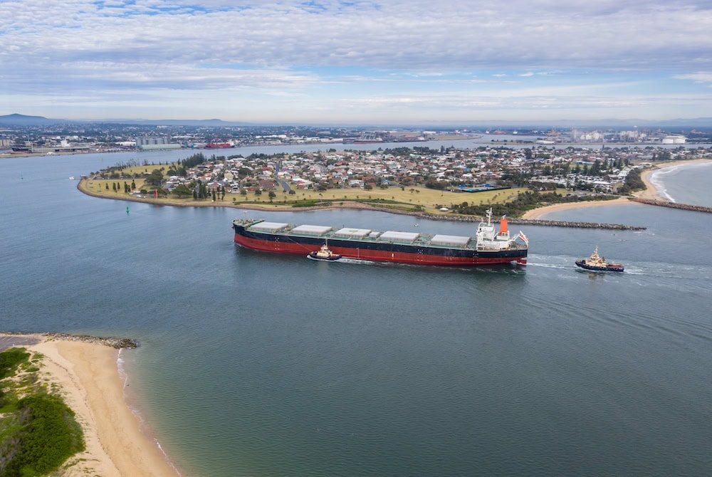 A large transport ship travelling through Newcastle Harbour; grain farmers have been keeping an eye on the Wheat Port Code.